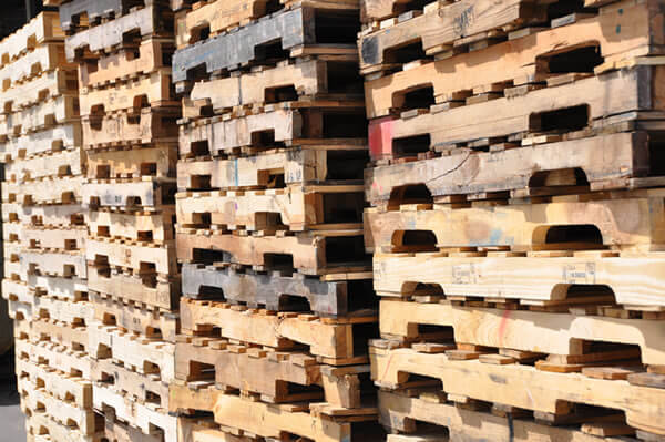 Stacks of recycled wooden pallets sorted for reuse